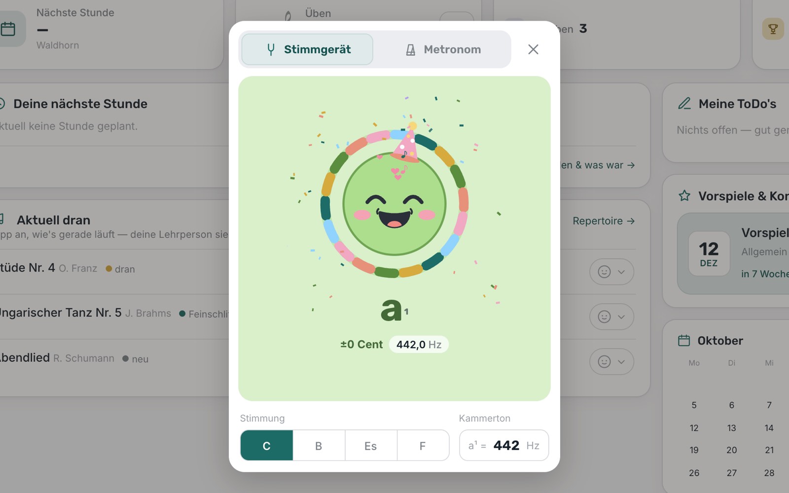 Das Stimmgerät mit Smiley: der Ton a¹ sitzt genau auf 442 Hz, das Gesicht lacht grün und feiert mit Hut und Konfetti